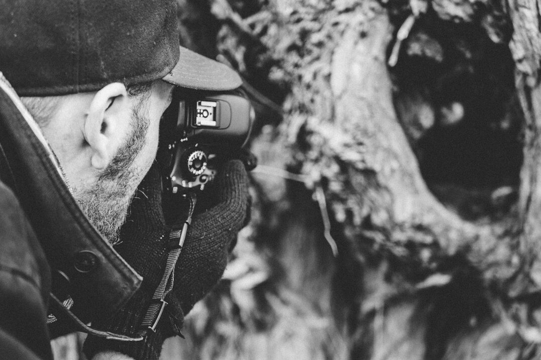 Documentary photographer on location with a camera