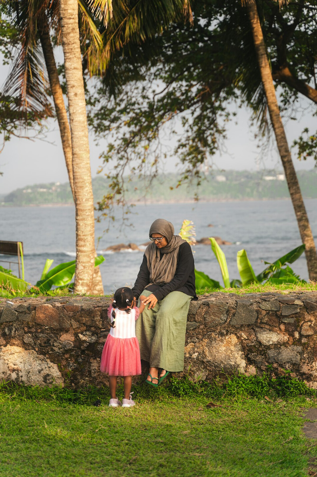 Grandmother and grandchild sitting together outdoors