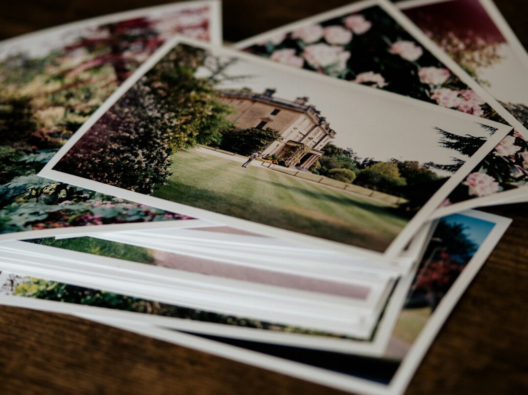 Printed photographs spread out on a table for editing