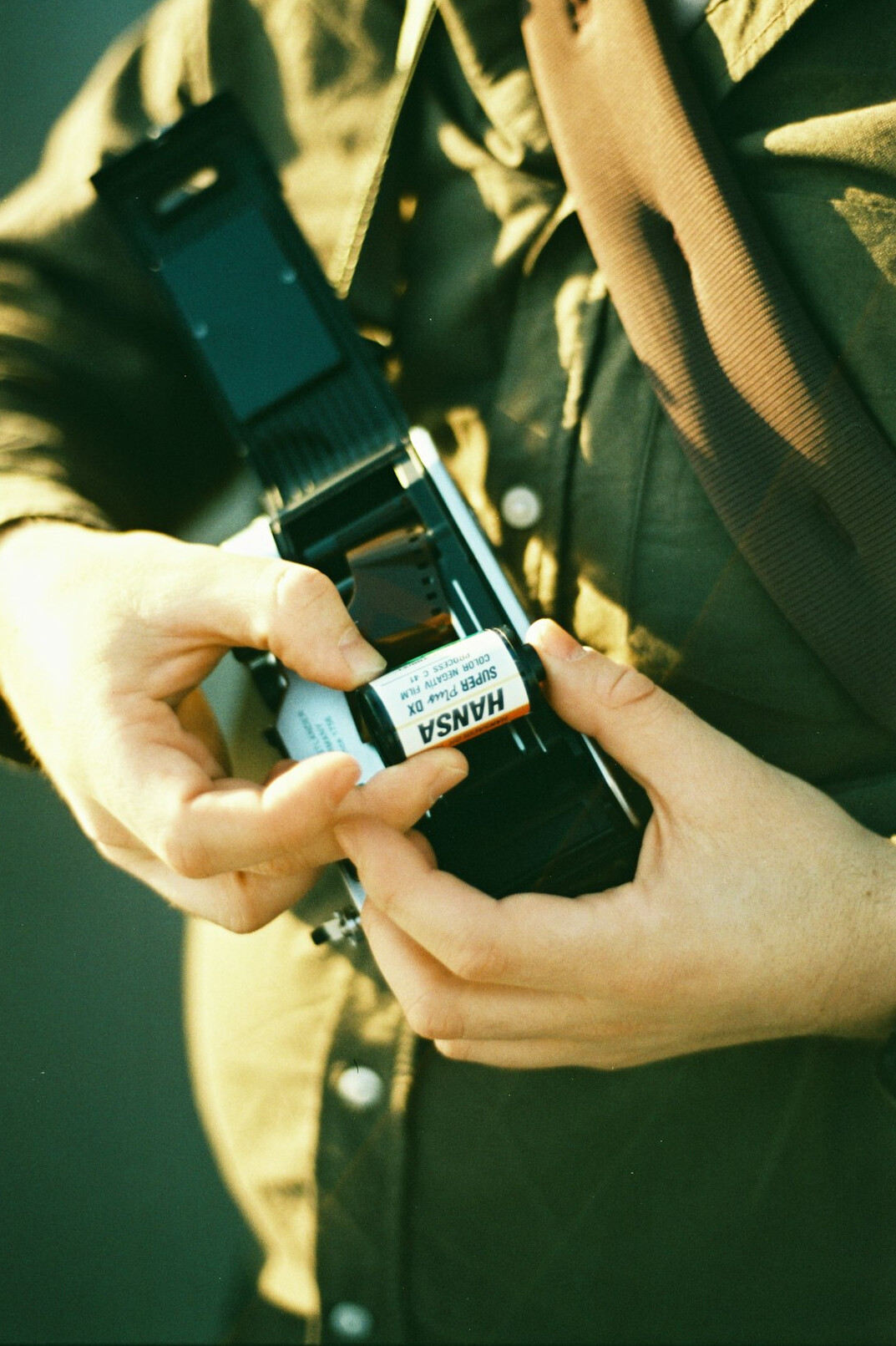 Photographer reviewing film negatives on a light table