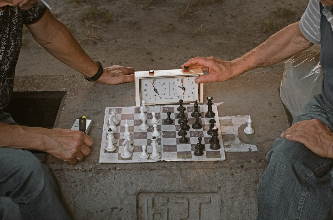 elderly men playing chess